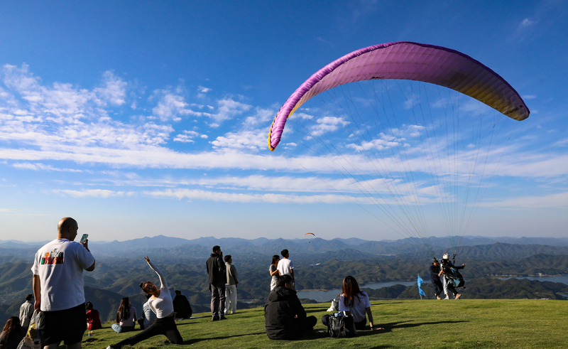 Huzhou: Touristen genie?en die Landschaft beim Gleitschirmfliegen